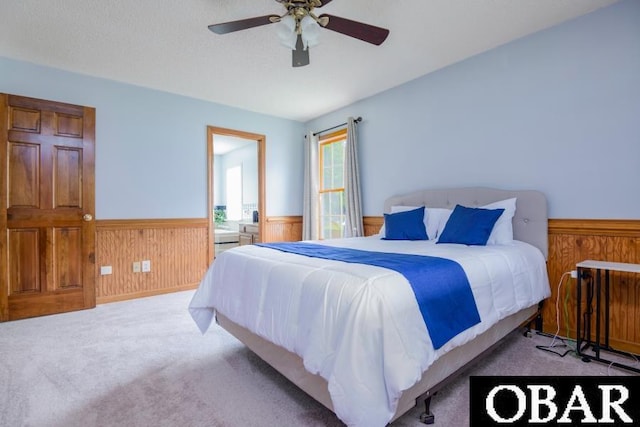 128 Daphne Ln Lot 17, Manteo, NC 27954 - carpeted bedroom featuring wainscoting, wood walls, and a ceiling fan