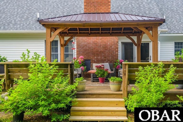128 Daphne Ln Lot 17, Manteo, NC 27954 - property entrance with a shingled roof, a deck, and brick siding