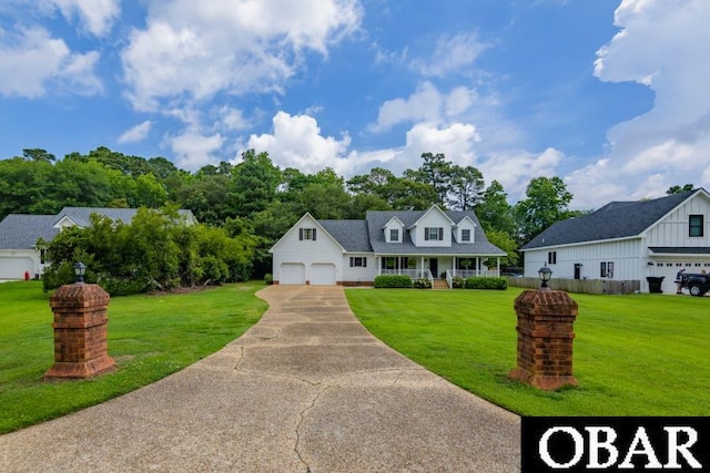 128 Daphne Ln Lot 17, Manteo, NC 27954 - cape cod-style house with an attached garage, a front yard, a porch, and driveway