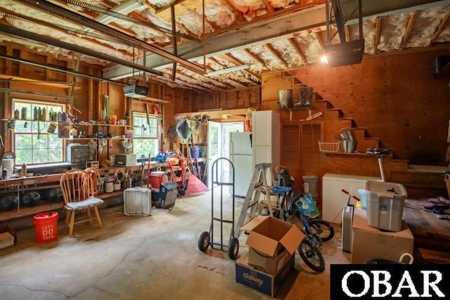 128 Daphne Ln Lot 17, Manteo, NC 27954 - garage with freestanding refrigerator, a garage door opener, and a workshop area