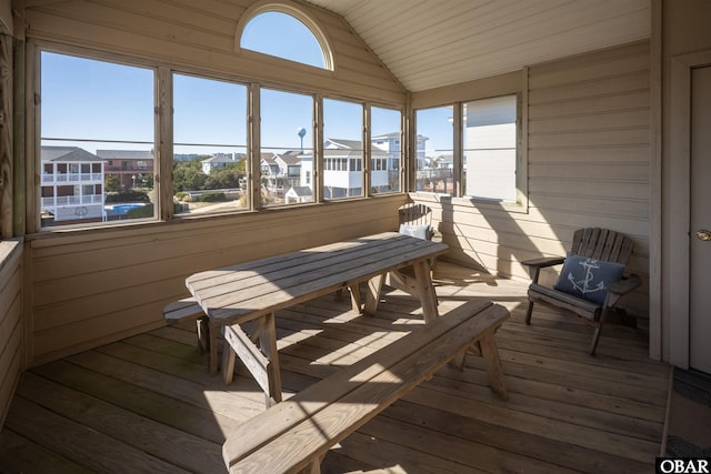 sunroom / solarium featuring vaulted ceiling and a wealth of natural light