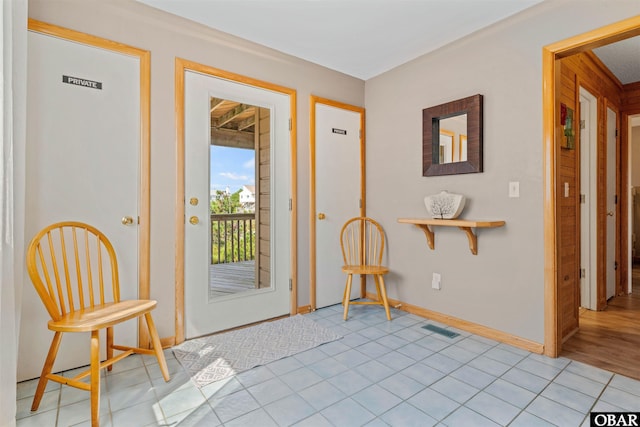 entrance foyer with baseboards, visible vents, and light tile patterned flooring