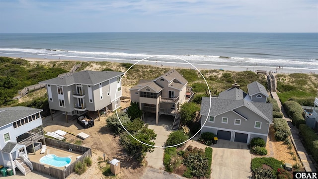 bird's eye view featuring a water view, a residential view, and a beach view