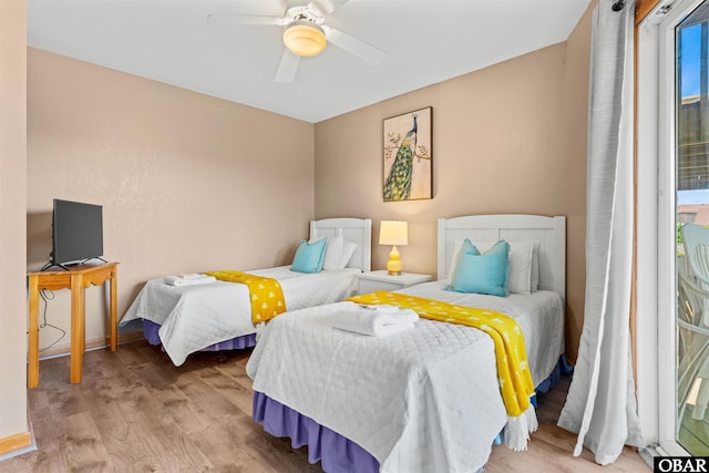 bedroom with multiple windows, ceiling fan, and light wood finished floors