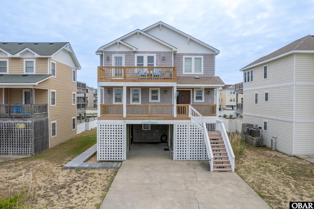 1309 S Memorial Blvd Lot 12, Kill Devil Hills, NC 27948 - view of front of property featuring a balcony, driveway, a carport, and stairway