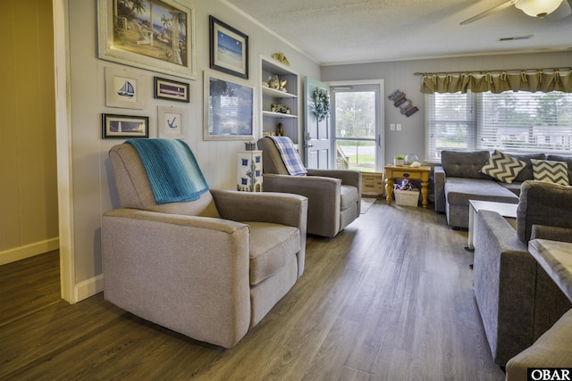 400 Driftwood Dr Lot 168, Elizabeth City, NC 27909 - living room featuring dark wood-style flooring, baseboards, built in features, a textured ceiling, and a ceiling fan