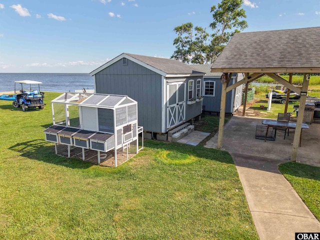 400 Driftwood Dr Lot 168, Elizabeth City, NC 27909 - rear view of house featuring exterior structure, a yard, a water view, and a shingled roof