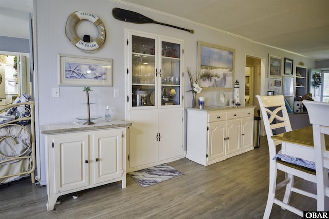 400 Driftwood Dr Lot 168, Elizabeth City, NC 27909 - kitchen with dark wood-style flooring, ornamental molding, white cabinets, light stone counters, and glass insert cabinets