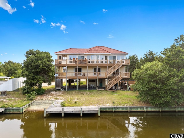 2250 Ocean Pearl Rd Lot 13, Corolla, NC 27927 - rear view of house featuring a deck with water view, stairway, and a tile roof