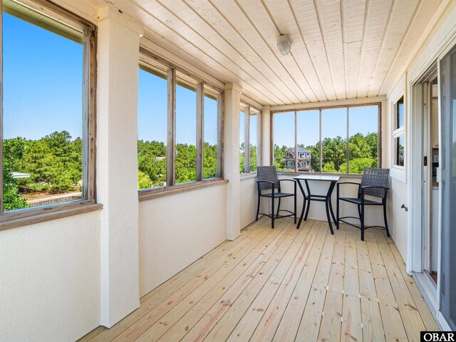 2250 Ocean Pearl Rd Lot 13, Corolla, NC 27927 - sunroom / solarium with hardwood / wood-style flooring, wood ceiling, and view of scattered trees