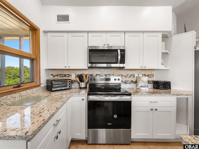 2250 Ocean Pearl Rd Lot 13, Corolla, NC 27927 - kitchen featuring stainless steel appliances, open shelves, tasteful backsplash, and white cabinetry