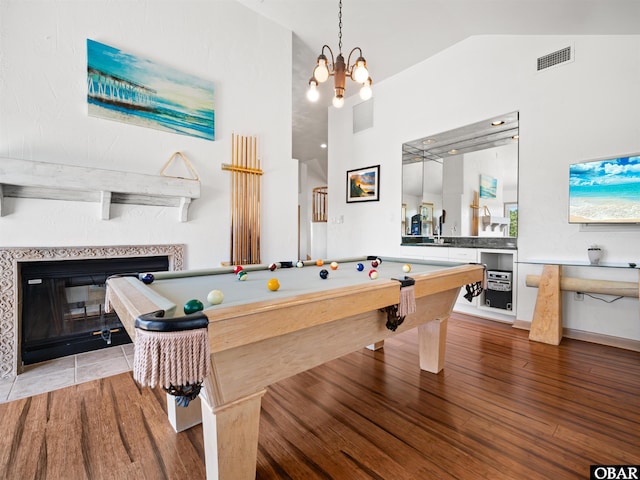 2250 Ocean Pearl Rd Lot 13, Corolla, NC 27927 - playroom featuring vaulted ceiling, billiards, wood finished floors, a tiled fireplace, and a chandelier