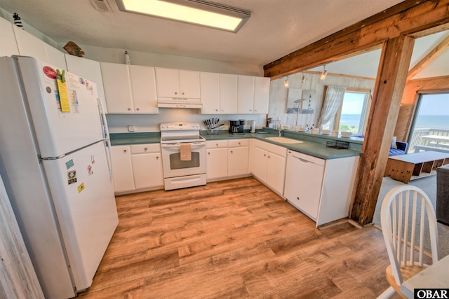 42075 Ocean View Dr Lot 3, Avon, NC 27943 - kitchen featuring white appliances, light wood finished floors, under cabinet range hood, white cabinetry, and dark countertops