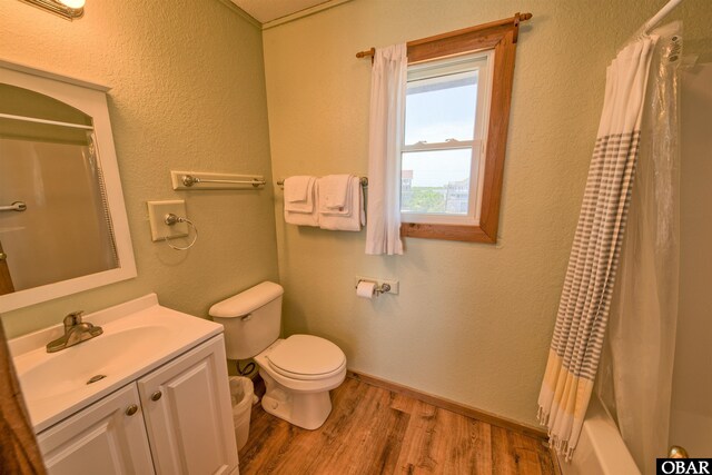 42075 Ocean View Dr Lot 3, Avon, NC 27943 - bathroom with toilet, wood finished floors, vanity, and shower / tub combo with curtain