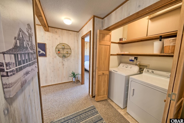 42075 Ocean View Dr Lot 3, Avon, NC 27943 - laundry room featuring independent washer and dryer, wood walls, a textured ceiling, baseboards, and crown molding