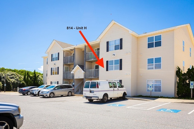 view of building exterior with uncovered parking