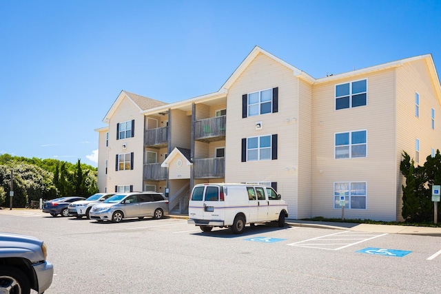 view of building exterior with uncovered parking