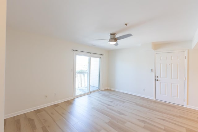 unfurnished room featuring light wood finished floors, a ceiling fan, and baseboards