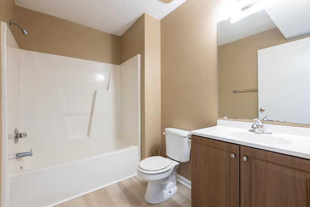 bathroom featuring shower / washtub combination, vanity, toilet, and wood finished floors