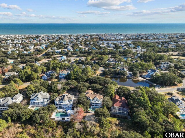 drone / aerial view with a water view and a residential view