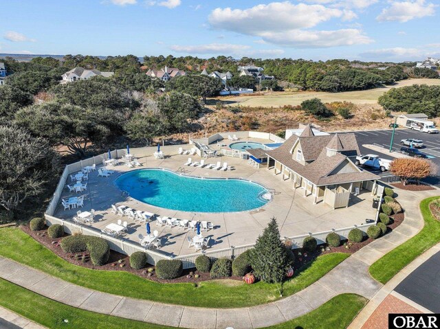 community pool featuring a patio area and fence