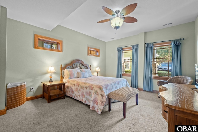 bedroom featuring light colored carpet, ceiling fan, visible vents, and baseboards