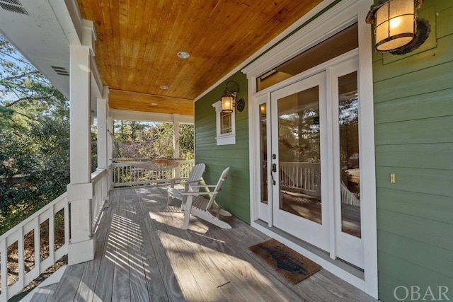 deck with visible vents and a porch