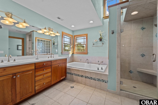 bathroom featuring visible vents, a sink, a shower stall, and a bath