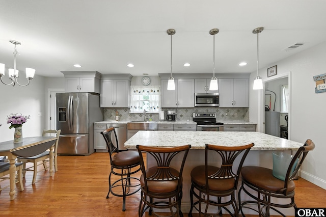 102 Lighthouse Vw Lot 5, Aydlett, NC 27916 - kitchen featuring appliances with stainless steel finishes, gray cabinets, light wood-style flooring, a chandelier, and recessed lighting