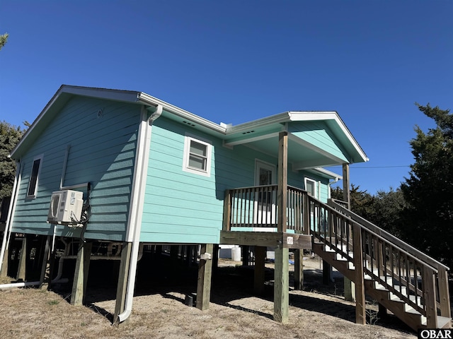 exterior space featuring covered porch, stairs, and a carport