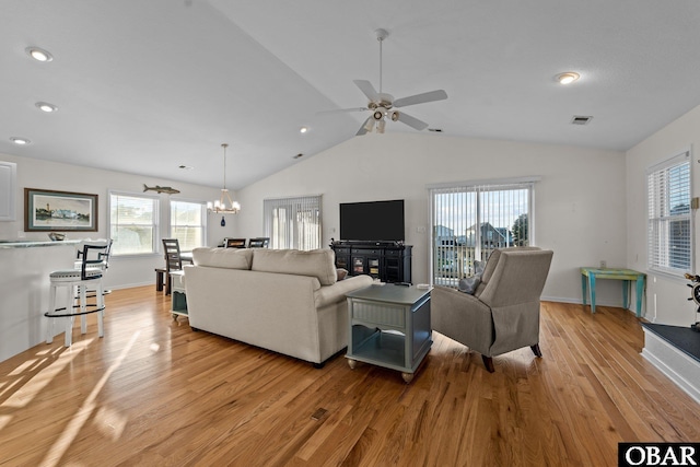 living area with visible vents, vaulted ceiling, light wood-style flooring, and baseboards