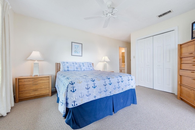 bedroom with light carpet, ceiling fan, visible vents, and a closet