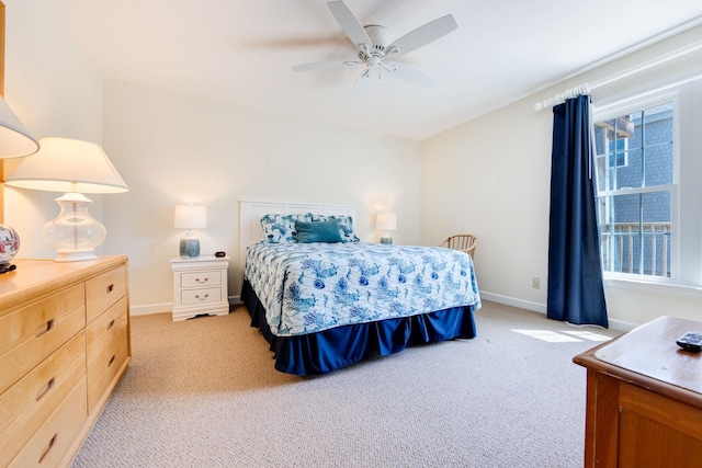 bedroom with ceiling fan, baseboards, and light colored carpet