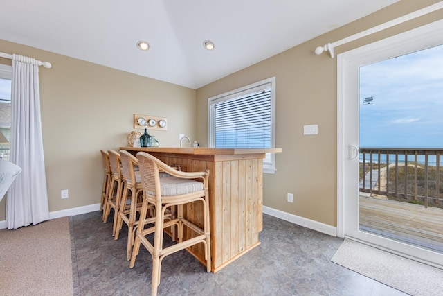 interior space featuring wet bar, baseboards, and recessed lighting