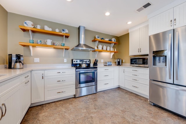 kitchen featuring stainless steel appliances, visible vents, white cabinets, light countertops, and wall chimney exhaust hood