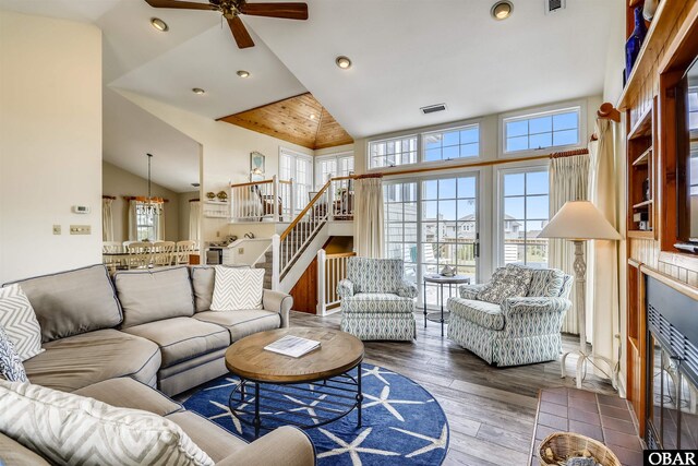 living room featuring stairs, visible vents, wood finished floors, and recessed lighting