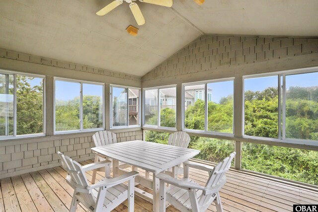 sunroom featuring vaulted ceiling and a ceiling fan