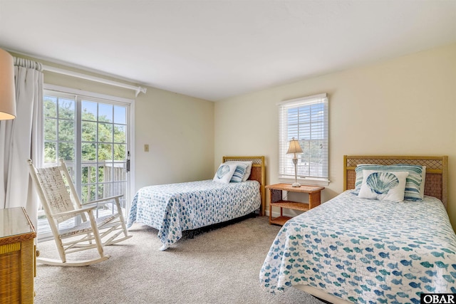 carpeted bedroom with access to outside