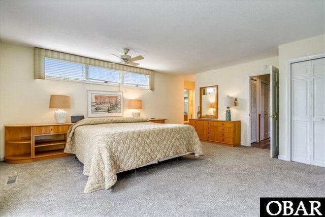 bedroom with ceiling fan, visible vents, and carpet flooring