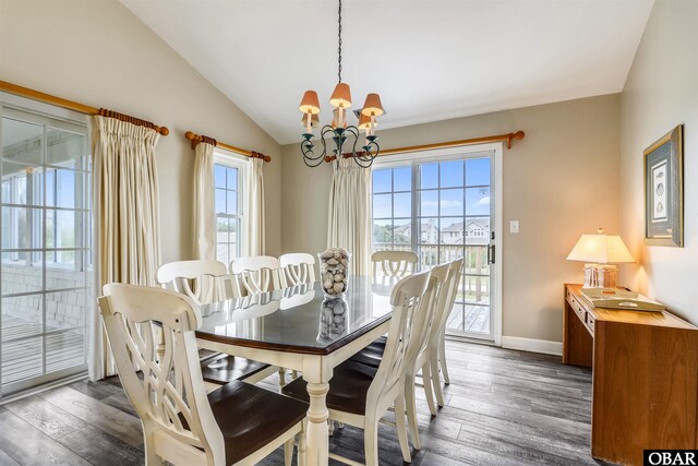 dining area featuring lofted ceiling, baseboards, a chandelier, and dark wood finished floors