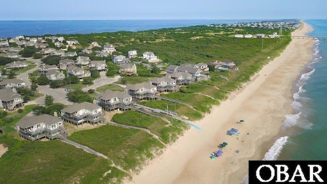 birds eye view of property with a water view, a residential view, and a view of the beach