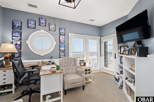 office with light carpet and visible vents