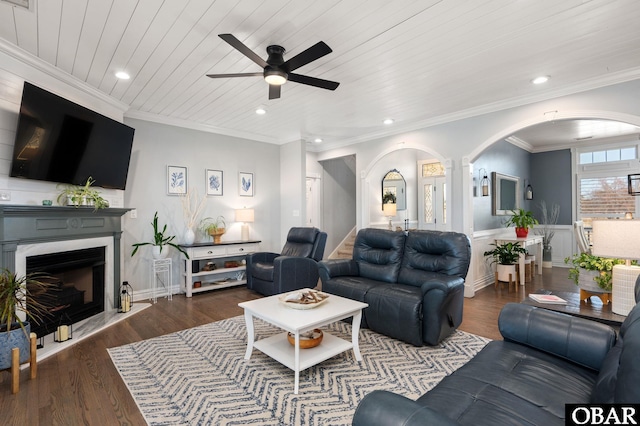 living area with arched walkways, dark wood-style flooring, wood ceiling, and crown molding