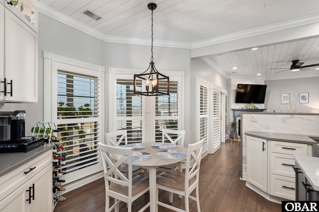 dining space featuring dark wood finished floors, wooden ceiling, crown molding, and ceiling fan with notable chandelier