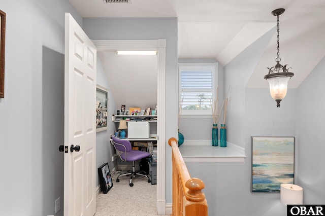 office space with vaulted ceiling, visible vents, and light colored carpet