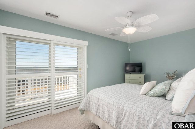 carpeted bedroom with ceiling fan and visible vents