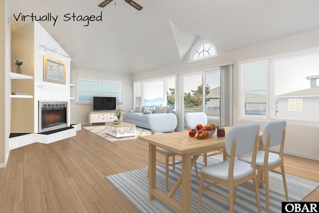 549 White Whale Way Lot # 220E, Corolla, NC 27927 - living room with a fireplace with raised hearth, light wood finished floors, a ceiling fan, high vaulted ceiling, and baseboards