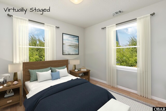 549 White Whale Way Lot # 220E, Corolla, NC 27927 - bedroom with wood finished floors, multiple windows, and baseboards