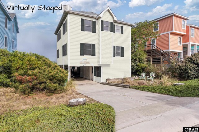 549 White Whale Way Lot # 220E, Corolla, NC 27927 - coastal inspired home featuring a carport, driveway, and a chimney