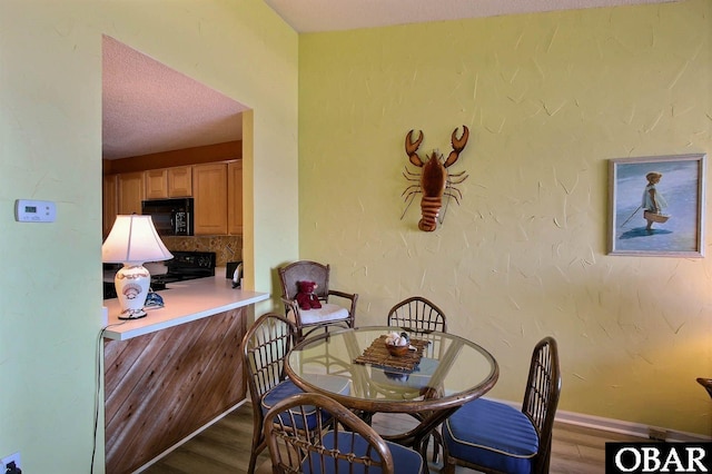 2035 S Virginia Dare Trl Unit 11, Kill Devil Hills, NC 27948 - dining room with wood finished floors and baseboards
